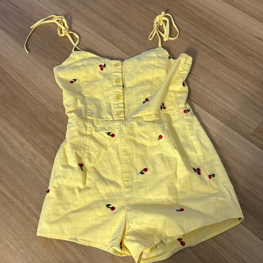 Yellow romper with cherry design